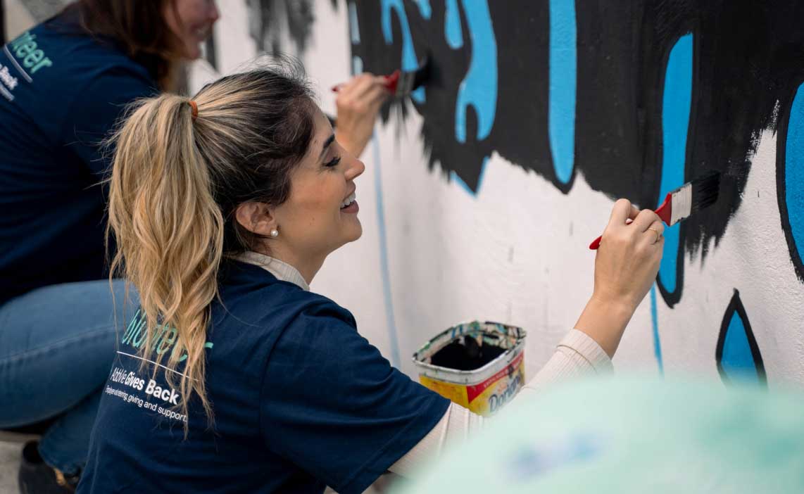 AbbVie employee helping to paint a mural